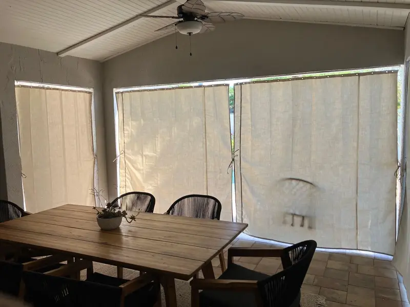 Cream Sunbrella privacy curtains for outdoor dining area in Sarasota lanai