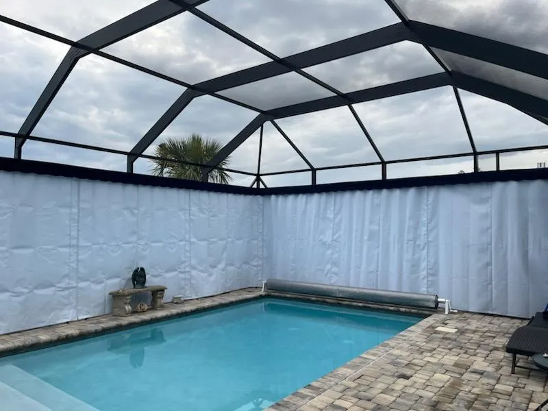 White Sunbrella lanai curtains around pool in Naples FL screen enclosure