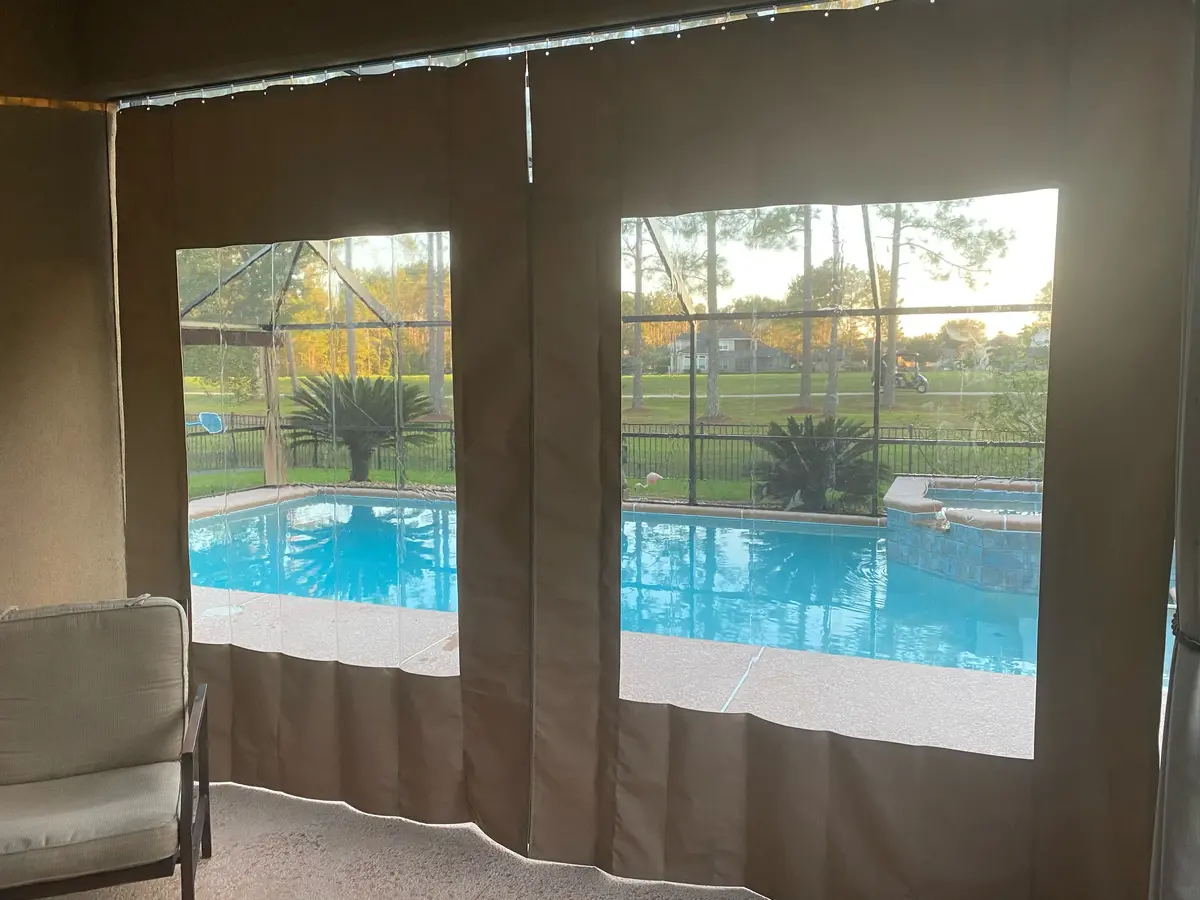 Canvas curtains with vinyl windows in Naples lanai overlooking pool