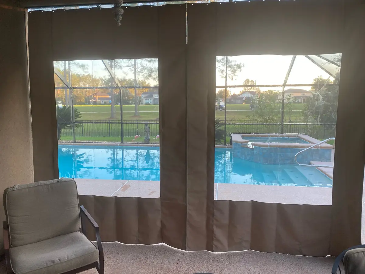 Sunbrella canvas curtains with clear vinyl windows overlooking Punta Gorda pool