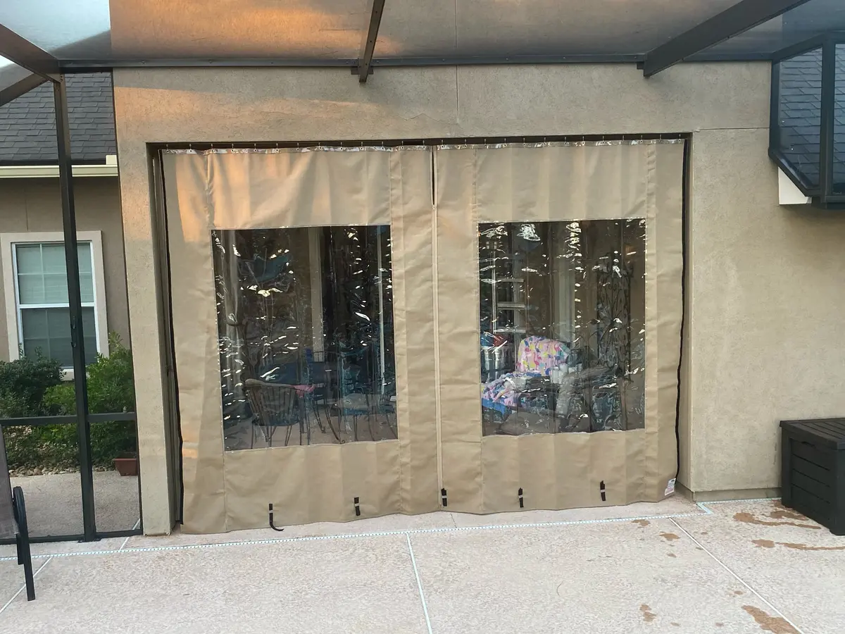 Tan Sunbrella curtains with clear vinyl windows on Punta Gorda patio enclosure
