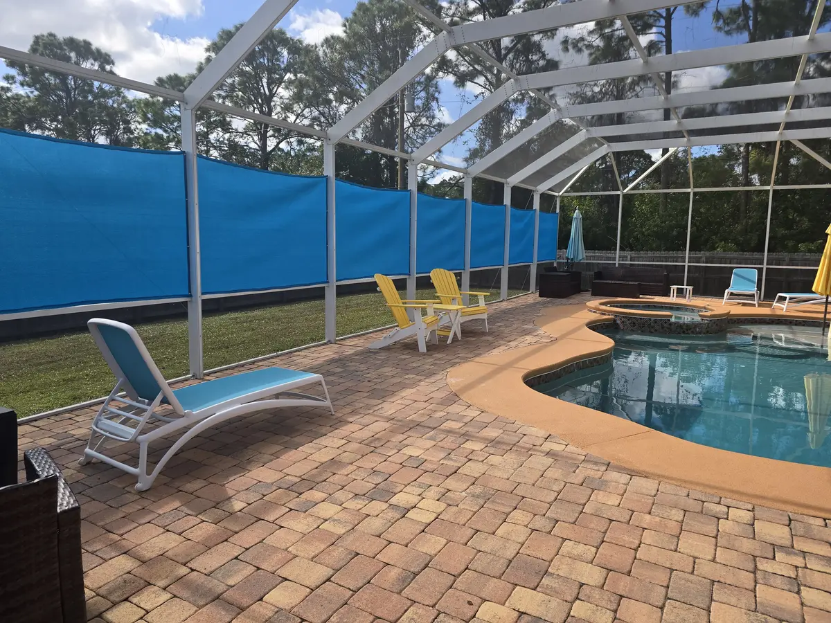 UV-stabilized privacy panels around paver patio in Sarasota pool area