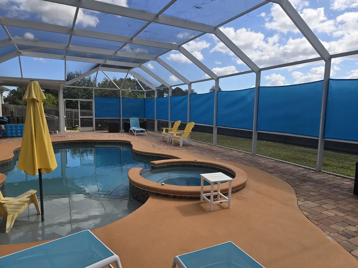 Blue UV-resistant mesh privacy panels permanently fitted in Punta Gorda pool cage