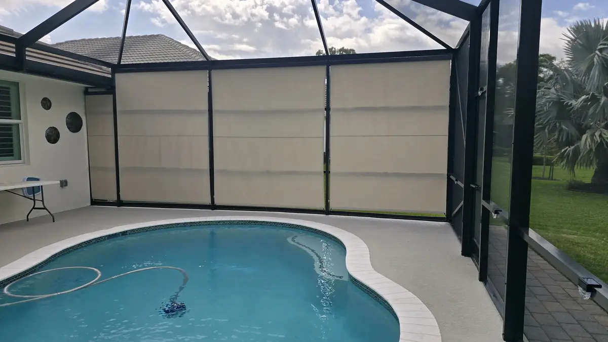 Beige privacy roller shades poolside in Fort Myers screen enclosure