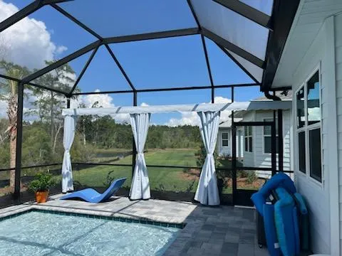 Cream roller shades in screen enclosure