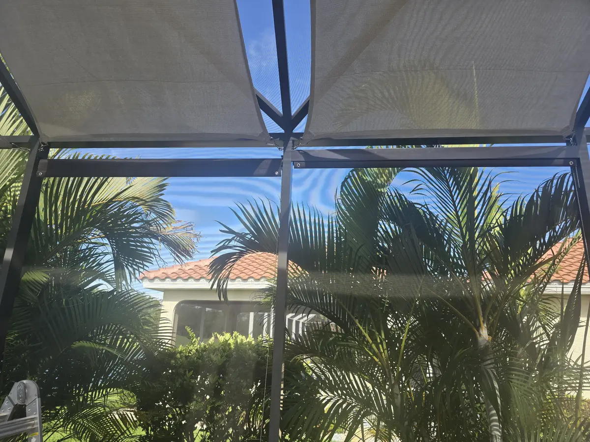 Tan solar screen roller shades with tropical landscaping in Punta Gorda patio