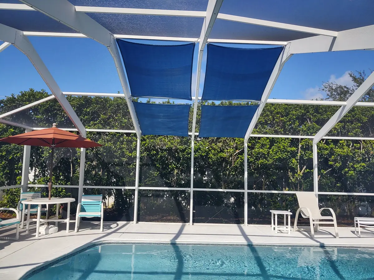 Beige shade sails in screen enclosure