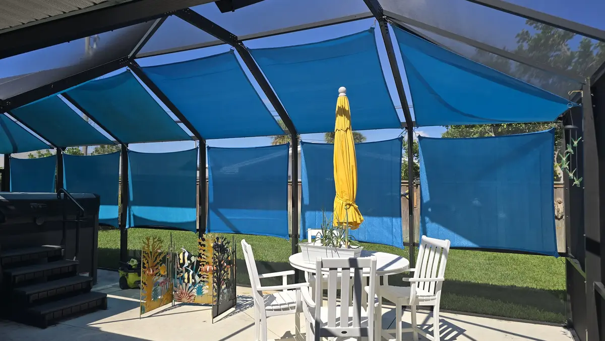 Blue HDPE mesh shade sails fitted inside Punta Gorda pool cage enclosure
