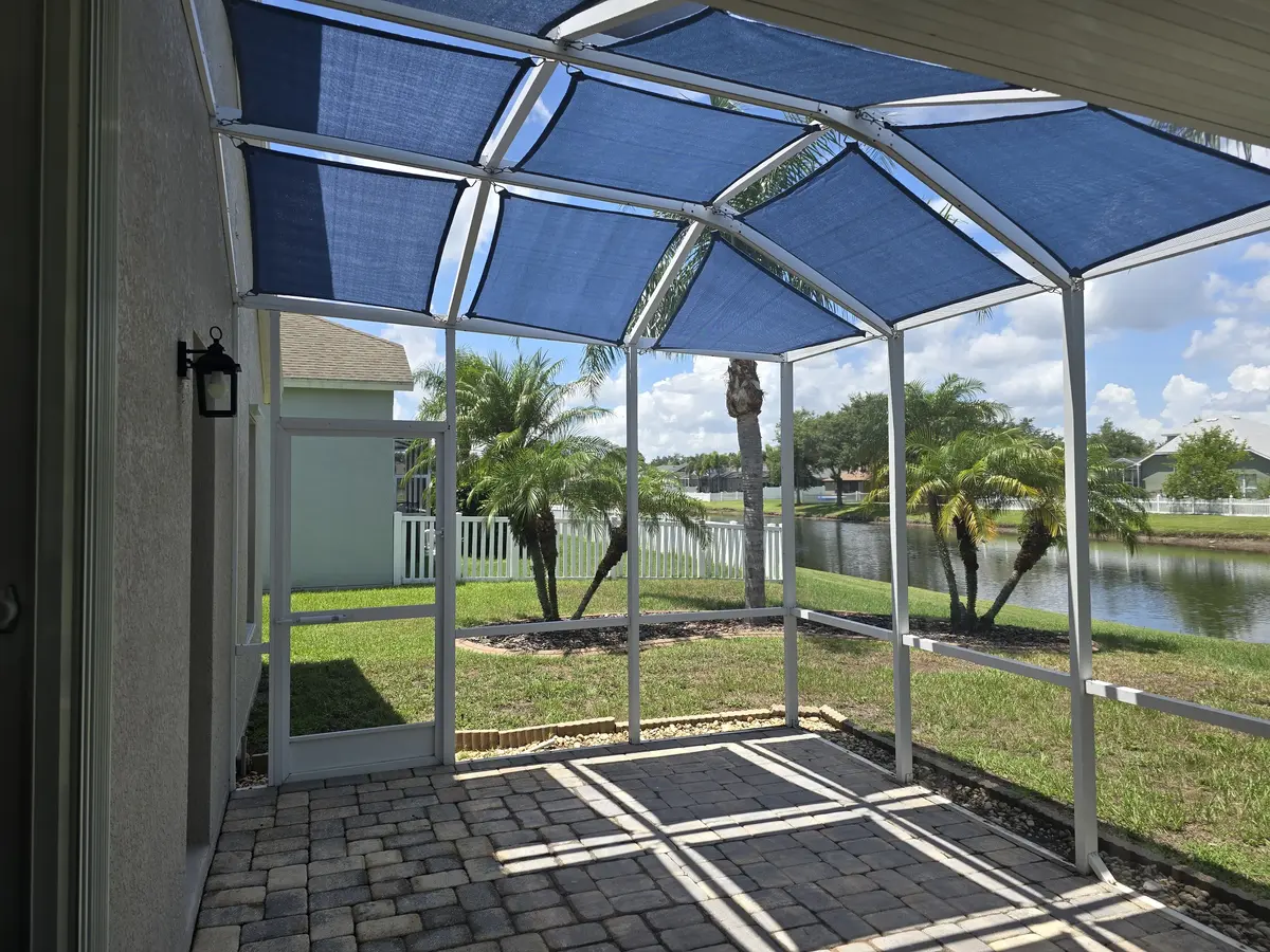 Blue shade sail in Florida pool cage